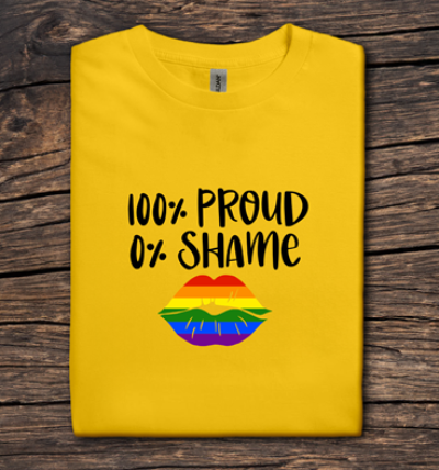 Yellow t-shirt with '100% Proud 0% Shame' text and rainbow design on a wooden surface