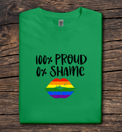 Green t-shirt with '100% Proud 0% Shame' text and rainbow lips design on a wooden surface