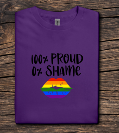 Purple t-shirt with '100% Proud 0% Shame' text and rainbow lips design on a wooden surface