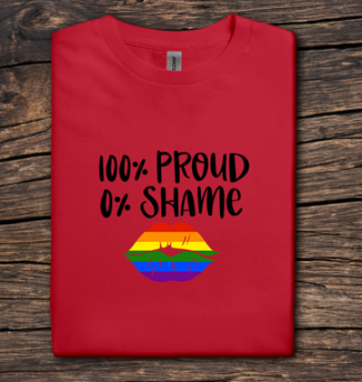 Red t-shirt with '100% Proud 0% Shame' text and rainbow design on a wooden surface