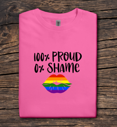 Pink t-shirt with '100% Proud 0% Shame' text and rainbow lips on a wooden surface