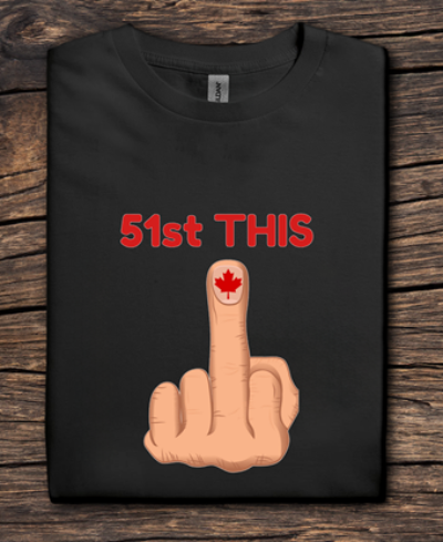 Black t-shirt with a graphic of a middle finger with a Canadian flag and text '51st THIS' on a wooden surface.