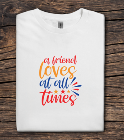 White t-shirt with colorful text on a wooden surface