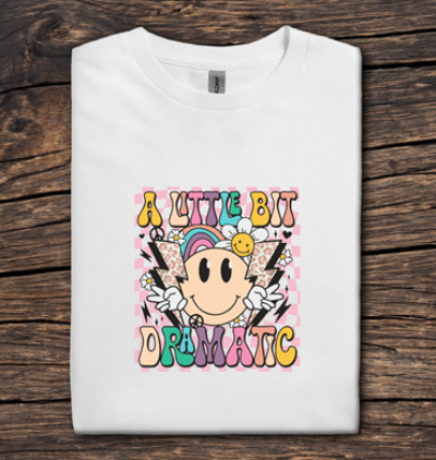 White t-shirt with colorful graphic design on a wooden surface