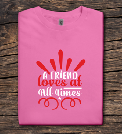 Pink t-shirt with red and white text on a wooden surface