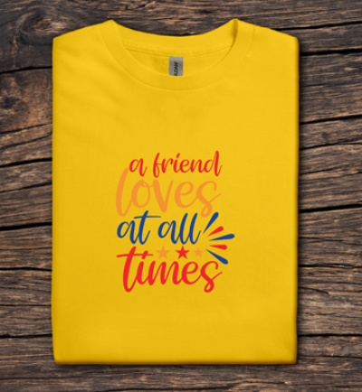 Yellow t-shirt with colorful text on a wooden surface