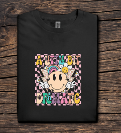 Black sweatshirt with colorful graphic design on a wooden surface