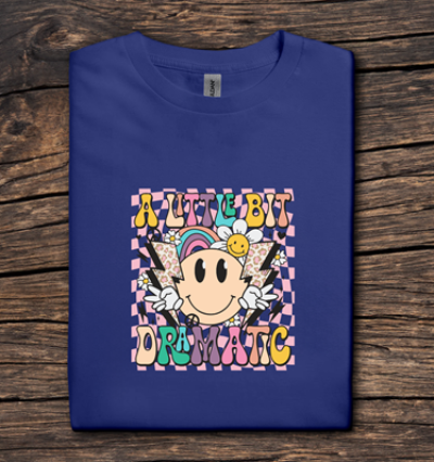 Blue t-shirt with colorful graphic design on a wooden surface