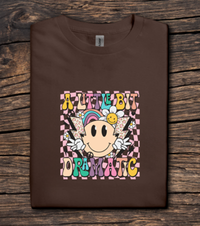 Brown t-shirt with colorful graphic design on a wooden surface