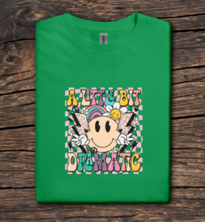 Green t-shirt with colorful graphic design on a wooden surface
