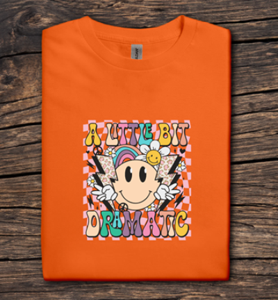 Orange t-shirt with colorful graphic design on a wooden surface