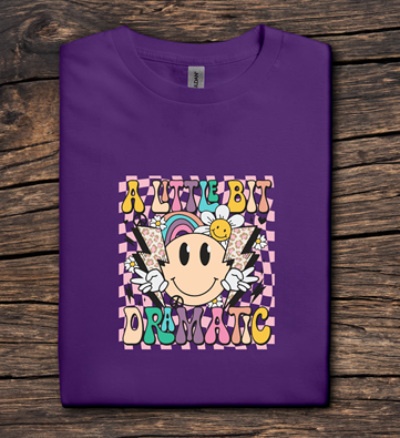 Purple t-shirt with colorful graphic design on a wooden surface