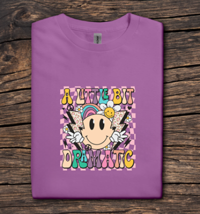 Purple t-shirt with colorful graphic design on a wooden surface