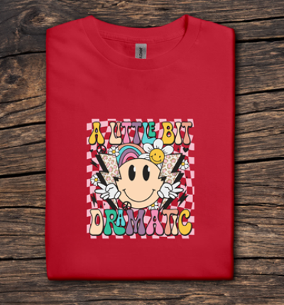 Red t-shirt with colorful graphic design on a wooden surface