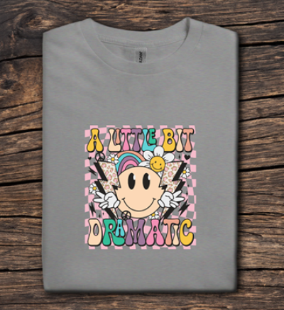 Gray t-shirt with colorful graphic design on a wooden surface