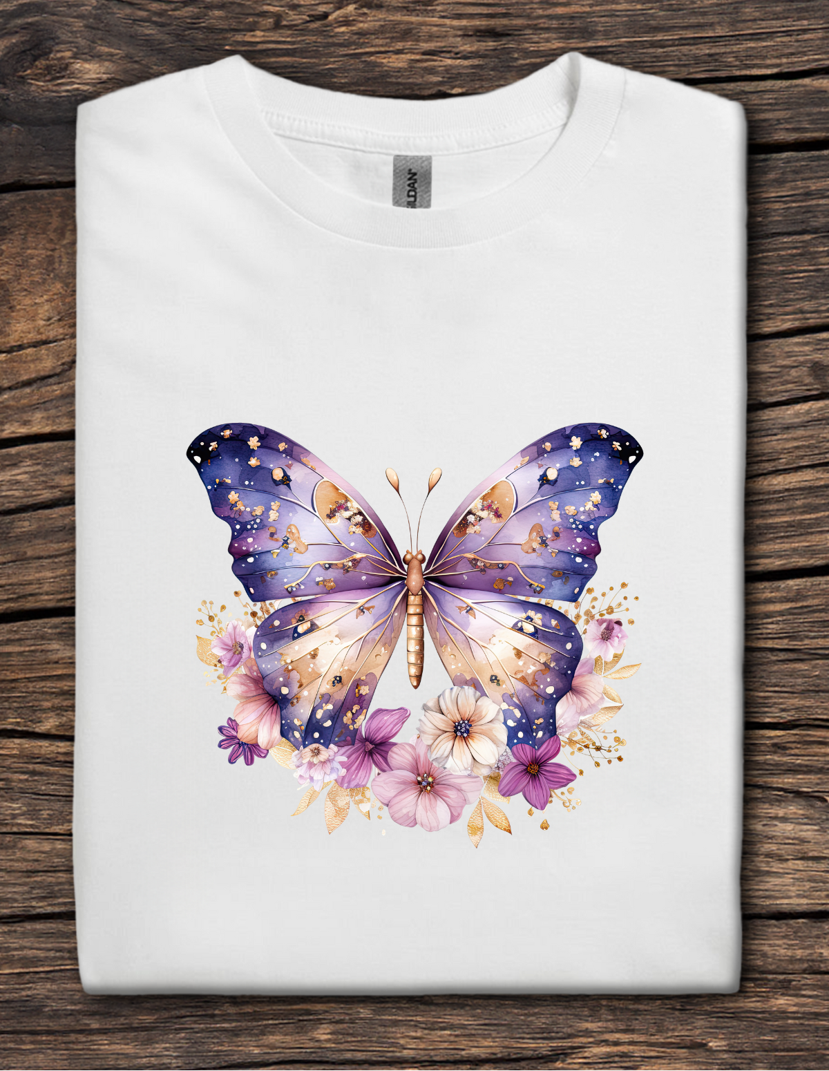 White t-shirt with a colorful butterfly design on a wooden surface