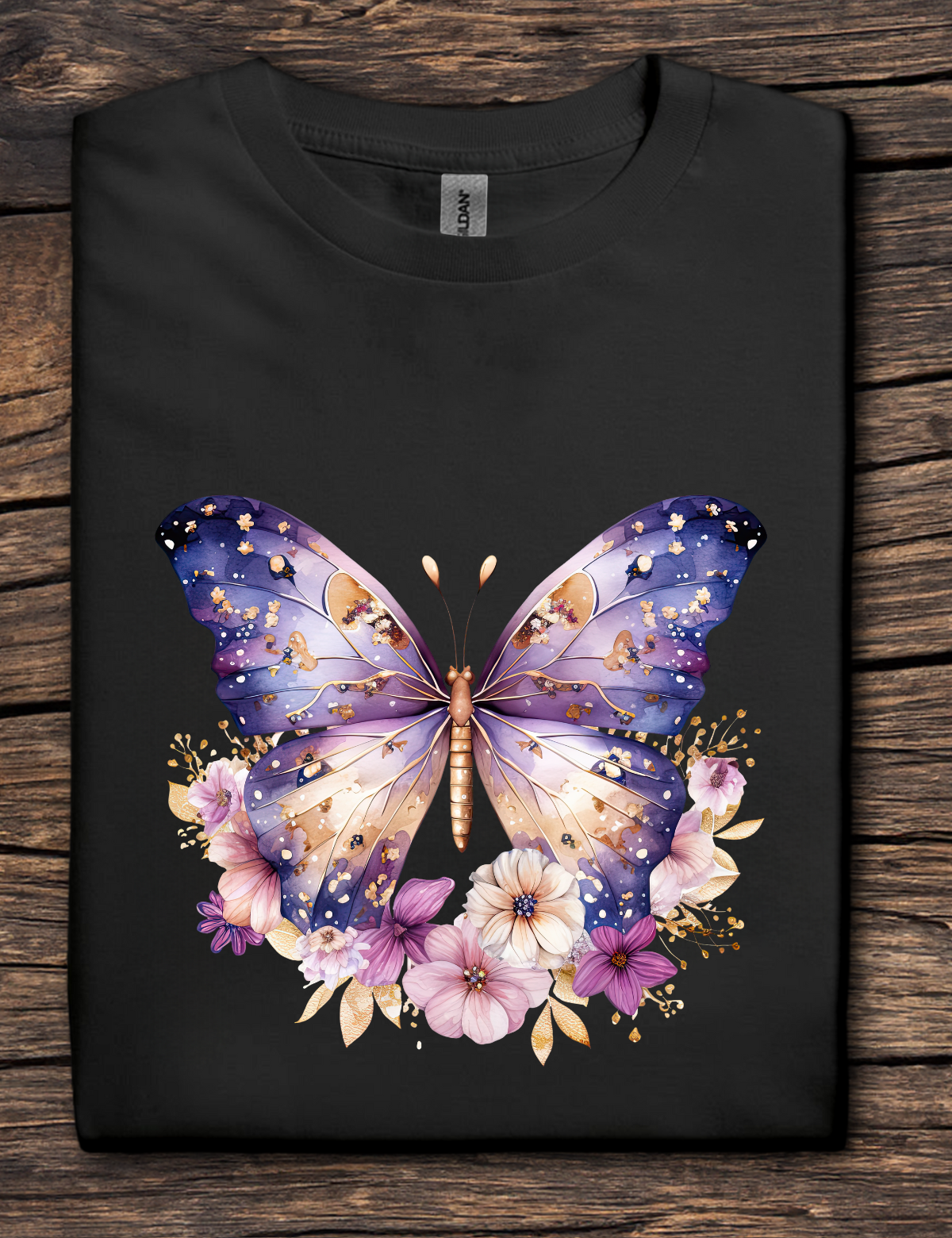 Black t-shirt with a colorful butterfly and floral design on a wooden surface
