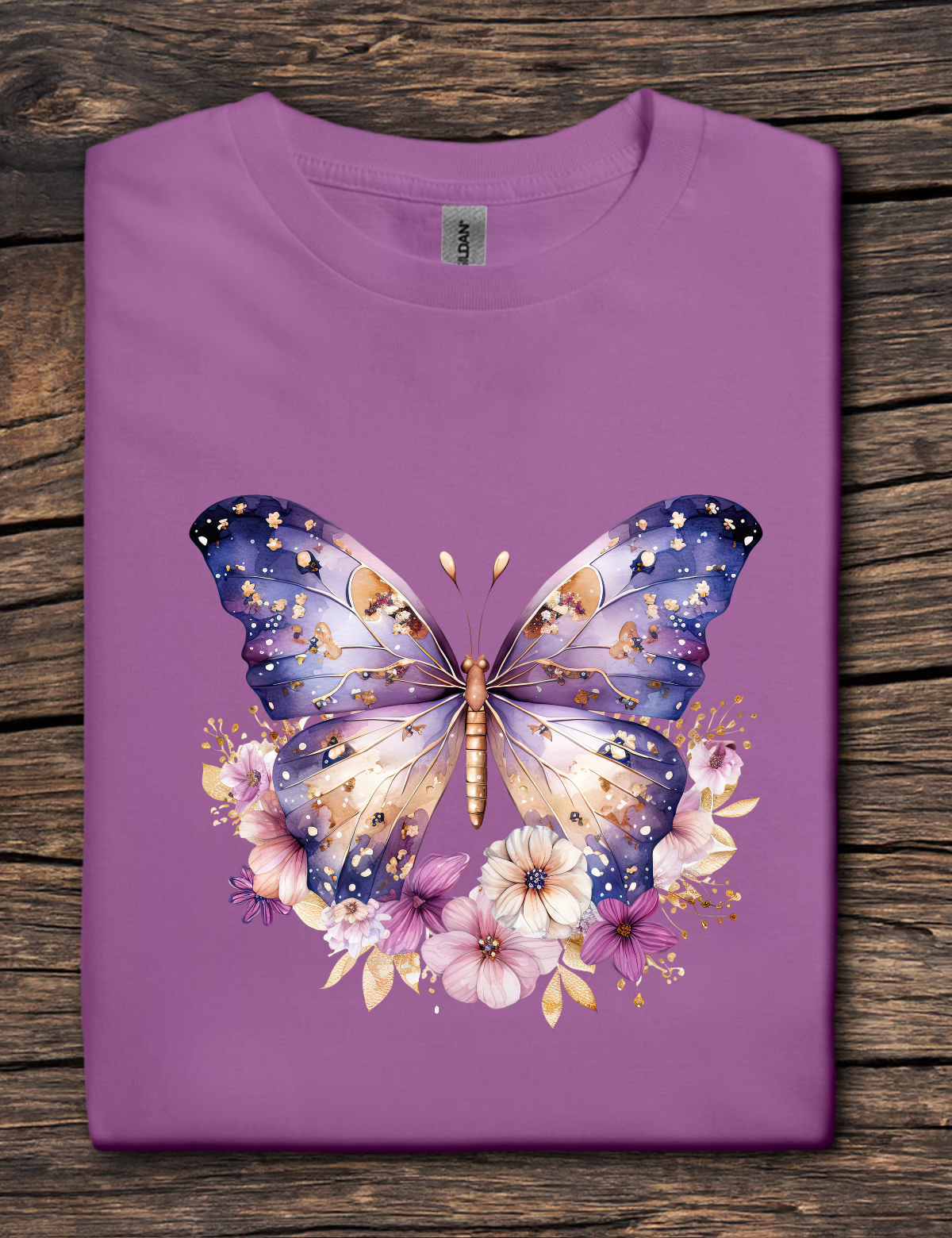 Purple t-shirt with a butterfly and floral design on a wooden surface