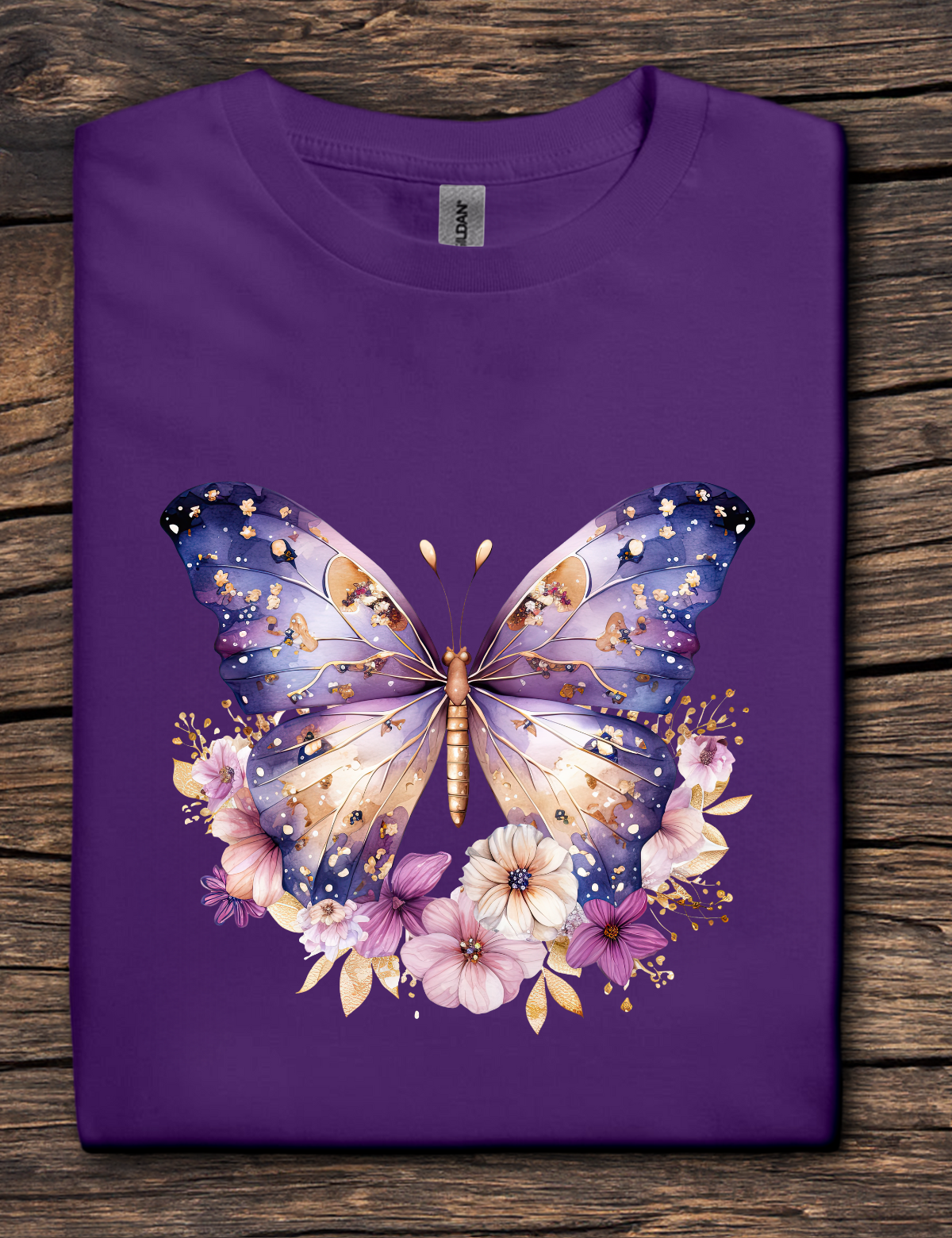 Purple t-shirt with a butterfly and floral design on a wooden surface
