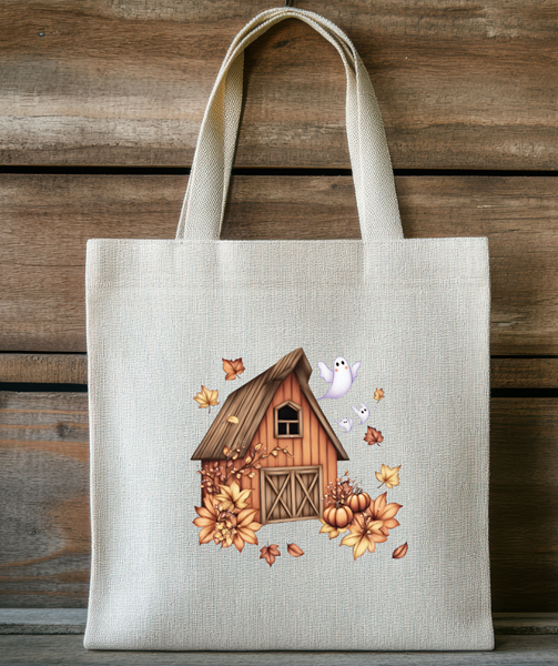 Tote bag with a wooden cabin and autumn-themed design on a wooden background