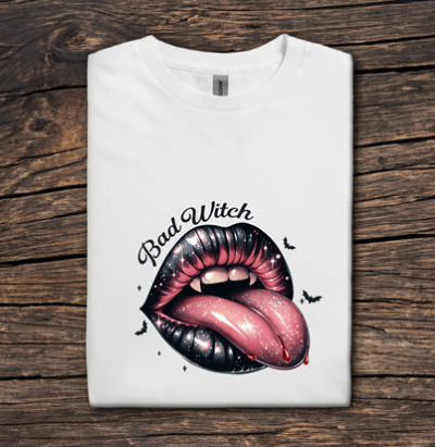 White t-shirt with a graphic of lips and 'Bad Witch' text on a wooden surface