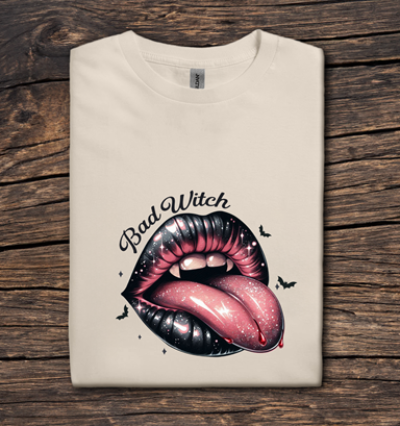 Beige t-shirt with a graphic of lips and 'Bad Witch' text on a wooden surface