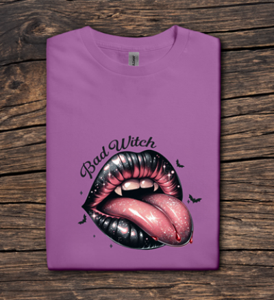 Purple t-shirt with a graphic of lips and 'Bad Witch' text on a wooden surface
