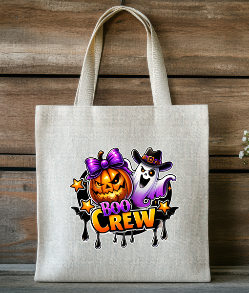 Boo Crew Halloween tote bag with smiling pumpkin wearing a purple bow and a friendly ghost on a natural fabric reusable bag.