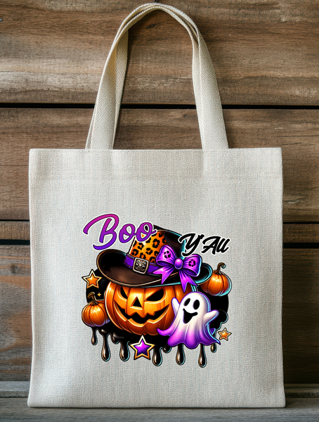 Boo Y’all Halloween tote bag featuring a jack-o’-lantern in a hat with a ghost and colorful spooky accents.