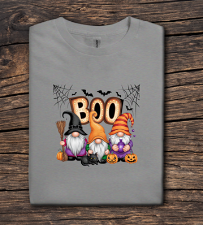 Gray t-shirt with Halloween-themed design featuring gnomes and 'BOO' text on a wooden surface