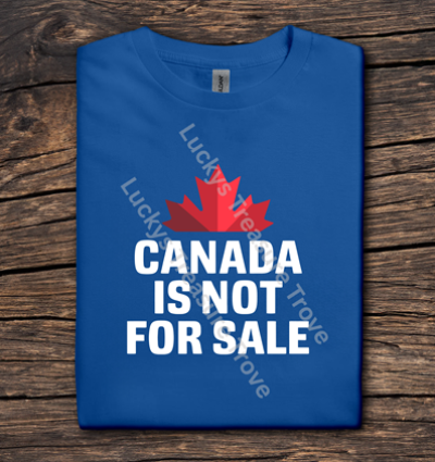 Blue t-shirt with red maple leaf and 'Canada is not for sale' text on a wooden surface