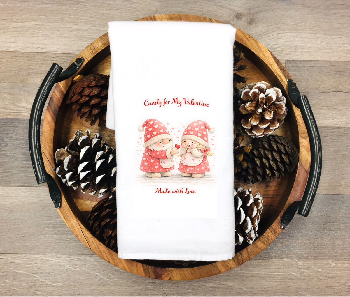 White kitchen towel featuring two Valentine gnomes sharing a heart candy with the phrases “Candy for My Valentine” and “Made with Love”