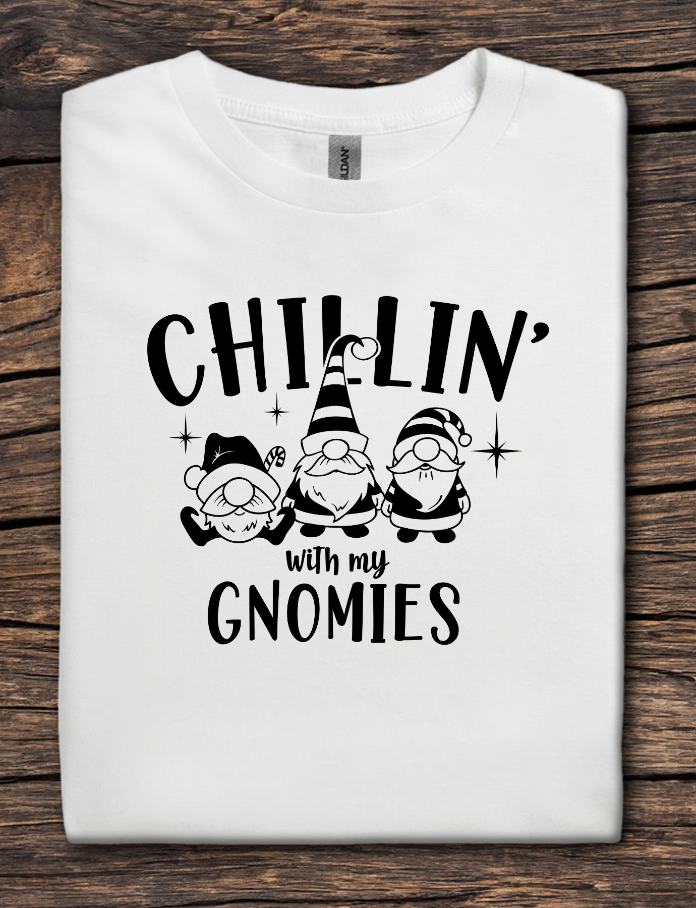 White t-shirt with black graphic text reading “Chillin’ With My Gnomies” and three winter gnome illustrations.