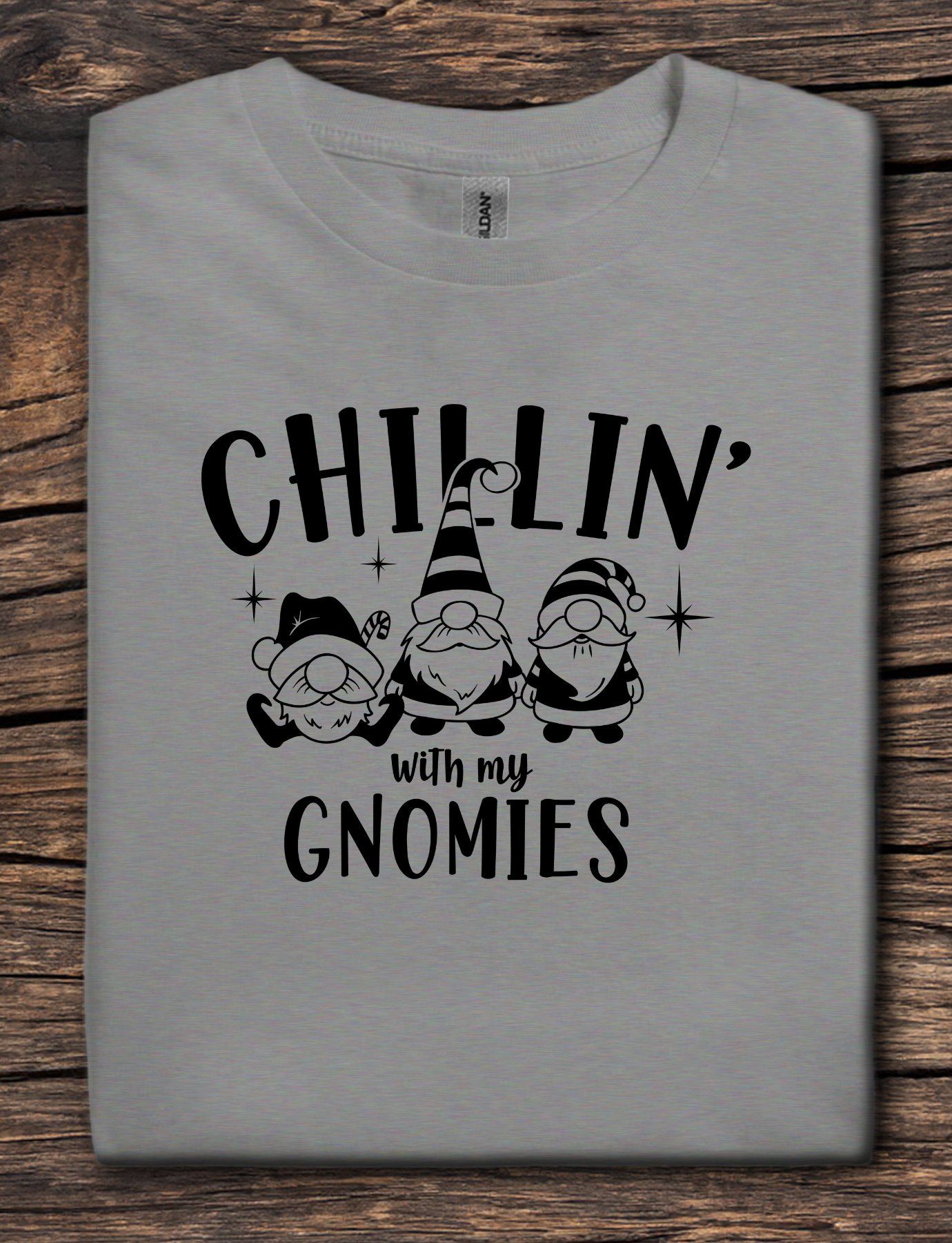 Gray t-shirt with black graphic text reading “Chillin’ With My Gnomies” and three winter gnome illustrations.