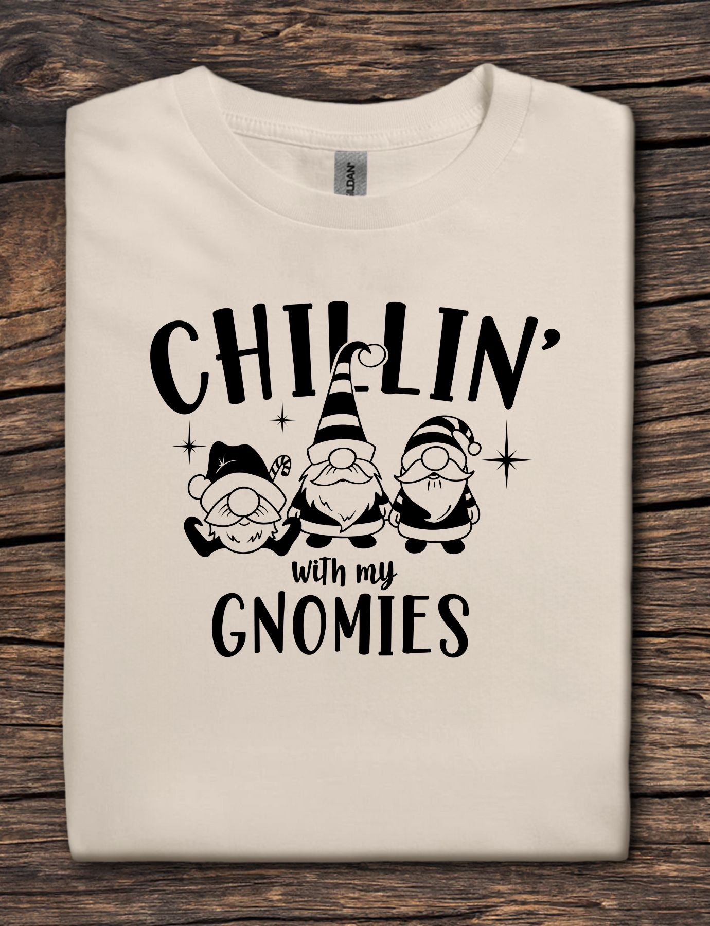 Beige t-shirt with black graphic text reading “Chillin’ With My Gnomies” and three winter gnome illustrations.
