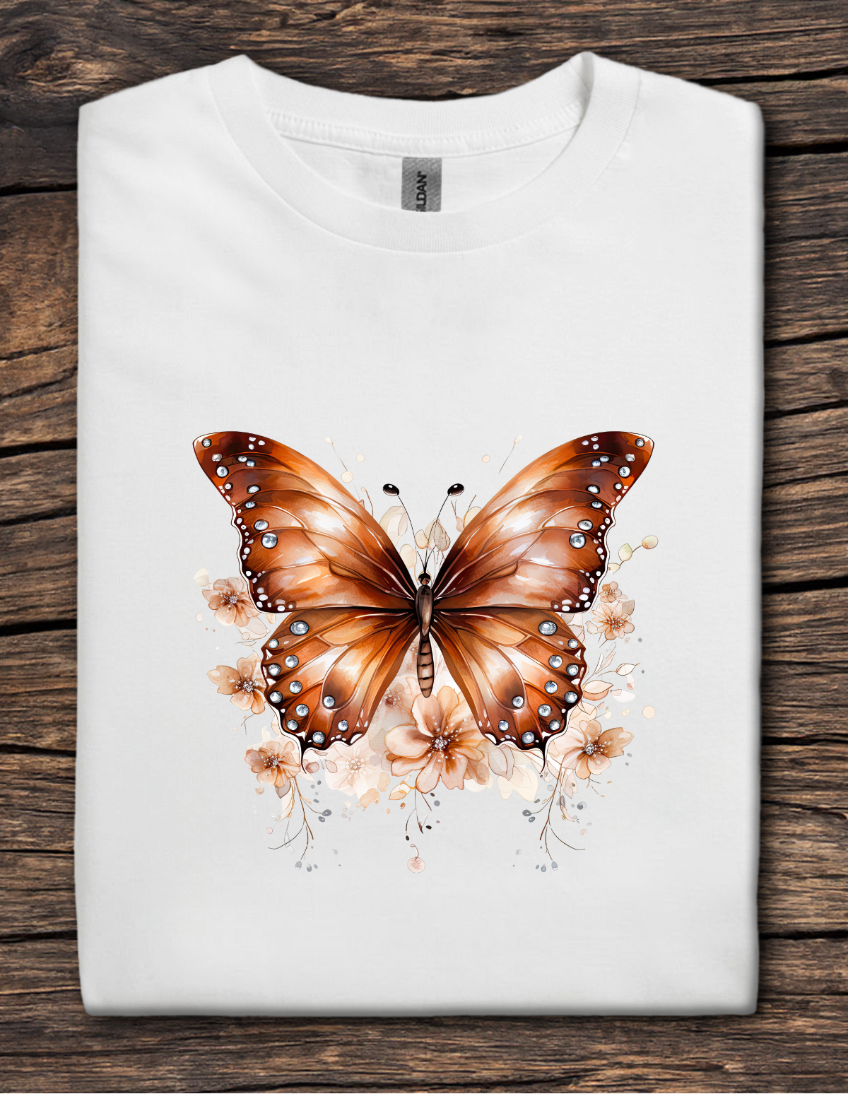 White t-shirt with copper-colored butterfly graphic surrounded by soft floral accents.