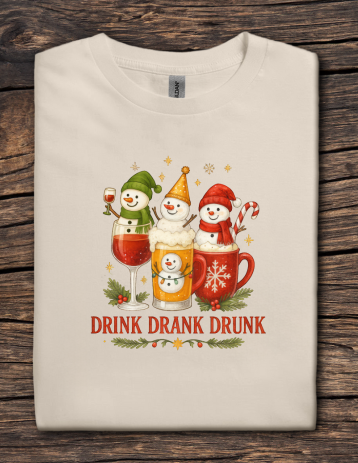 Beige Christmas t-shirt with three snowmen holding festive drinks and the phrase Drink Drank Drunk.