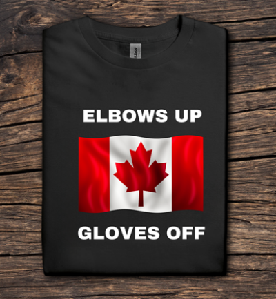 Black t-shirt with Canadian flag and text 'ELBOWS UP GLOVES OFF' on a wooden surface