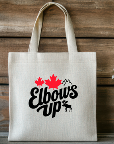 Tote bag with 'Elbows Up' text and red maple leaf design on a wooden background