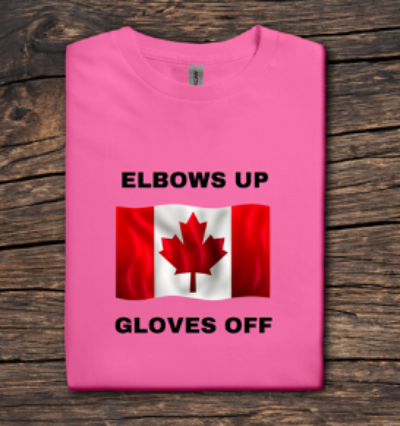 Pink t-shirt with Canadian flag and text on a wooden surface