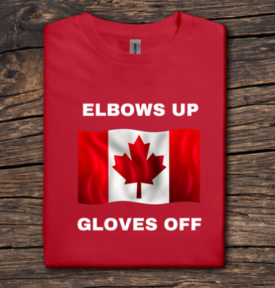 Red t-shirt with Canadian flag and text 'ELBOWS UP GLOVES OFF' on a wooden surface