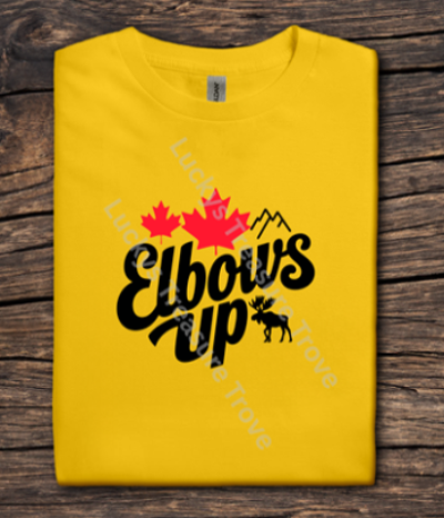 Yellow t-shirt with 'Elbows Up' text and red maple leaves on a wooden surface