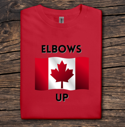 Red t-shirt with Canadian flag and 'ELBOWS UP' text on a wooden surface
