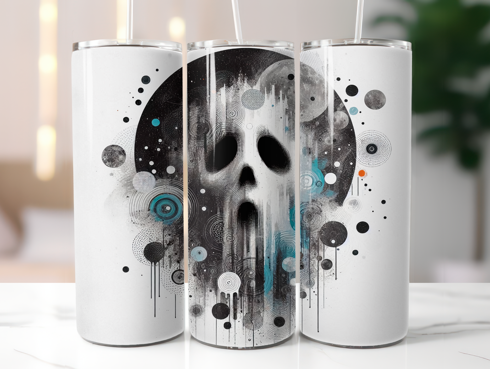 Three white tumblers with black and gray skull design on a white surface.