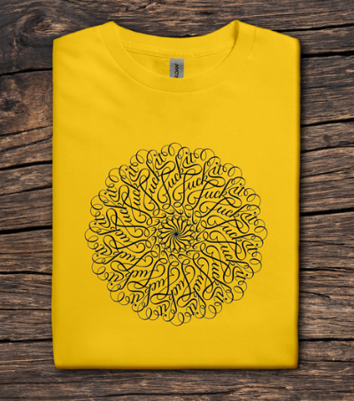 Yellow t-shirt with black circular design on a wooden surface
