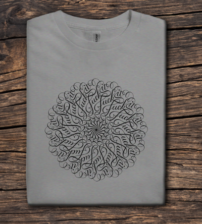 Gray t-shirt with a black circular design on a wooden surface