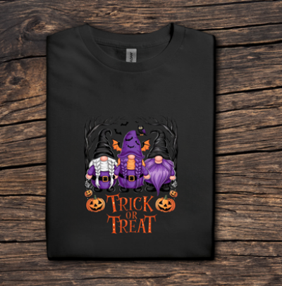 Black t-shirt with Halloween-themed design featuring gnomes and pumpkins on a wooden surface