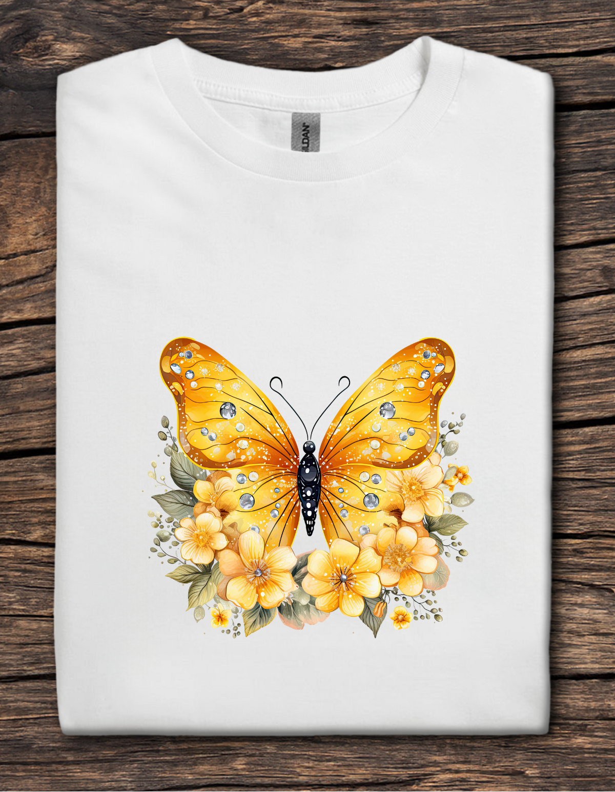 White t-shirt with a golden yellow butterfly surrounded by yellow flowers and jeweled details.