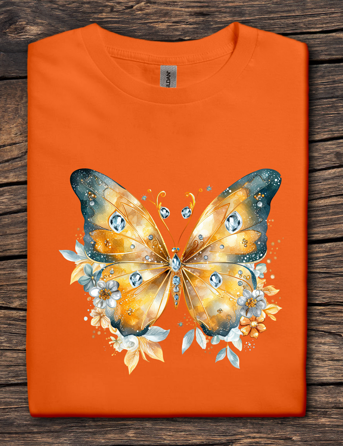 Orange t-shirt with a butterfly design on a wooden surface