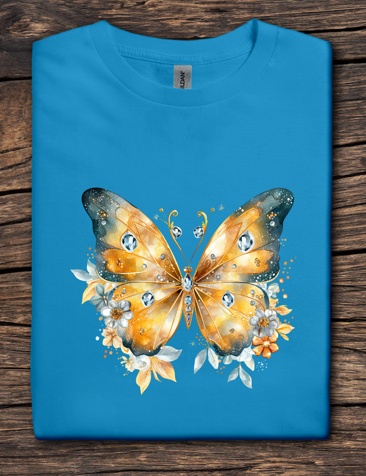 Blue t-shirt with a colorful butterfly design on a wooden surface